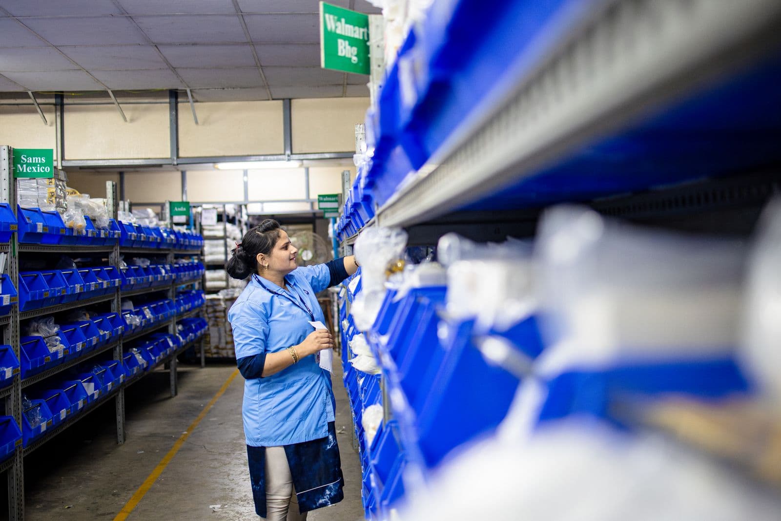 Worker checking goods inside a temperature-controlled cold-chain warehouse