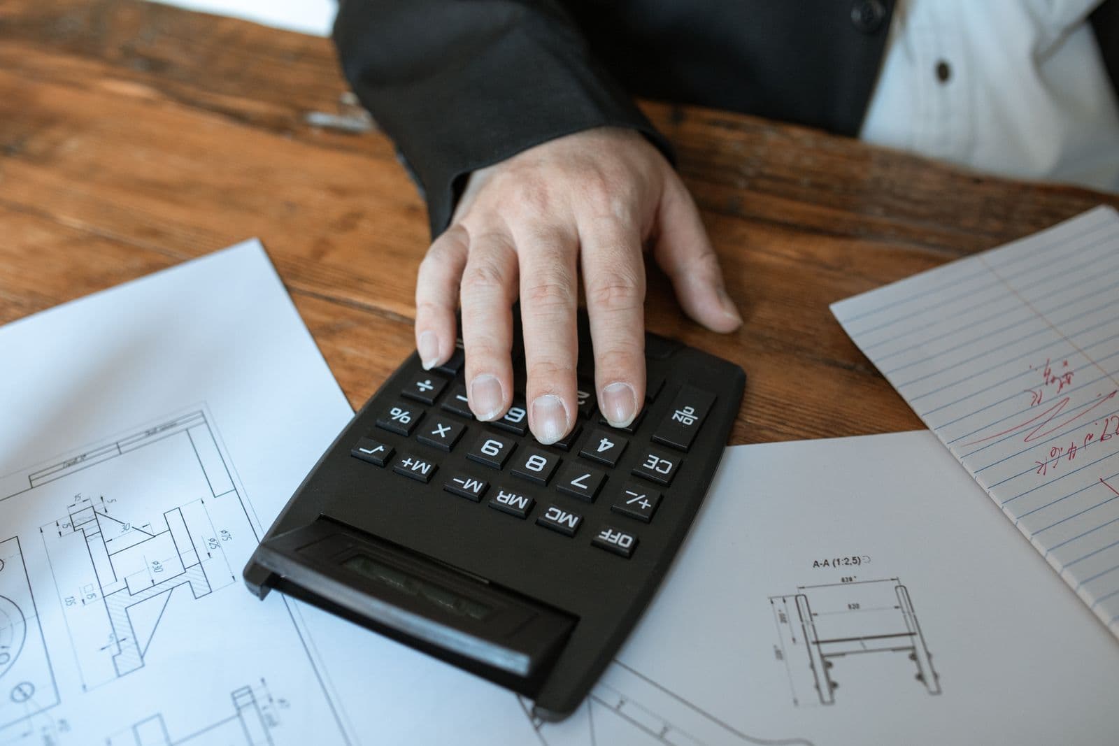 Calculator and paperwork used to prepare a same day courier quote