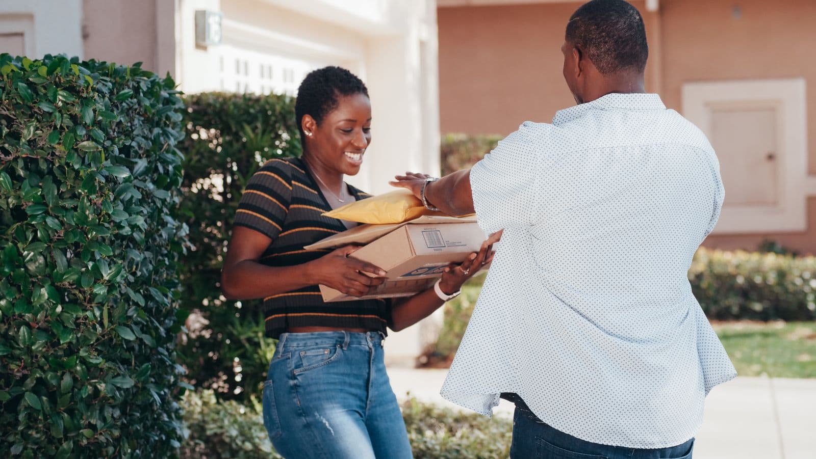 Courier handling a parcel before a comparison of dedicated and network delivery