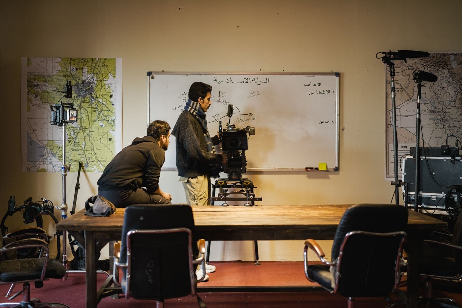 Film crew preparing professional camera equipment on location
