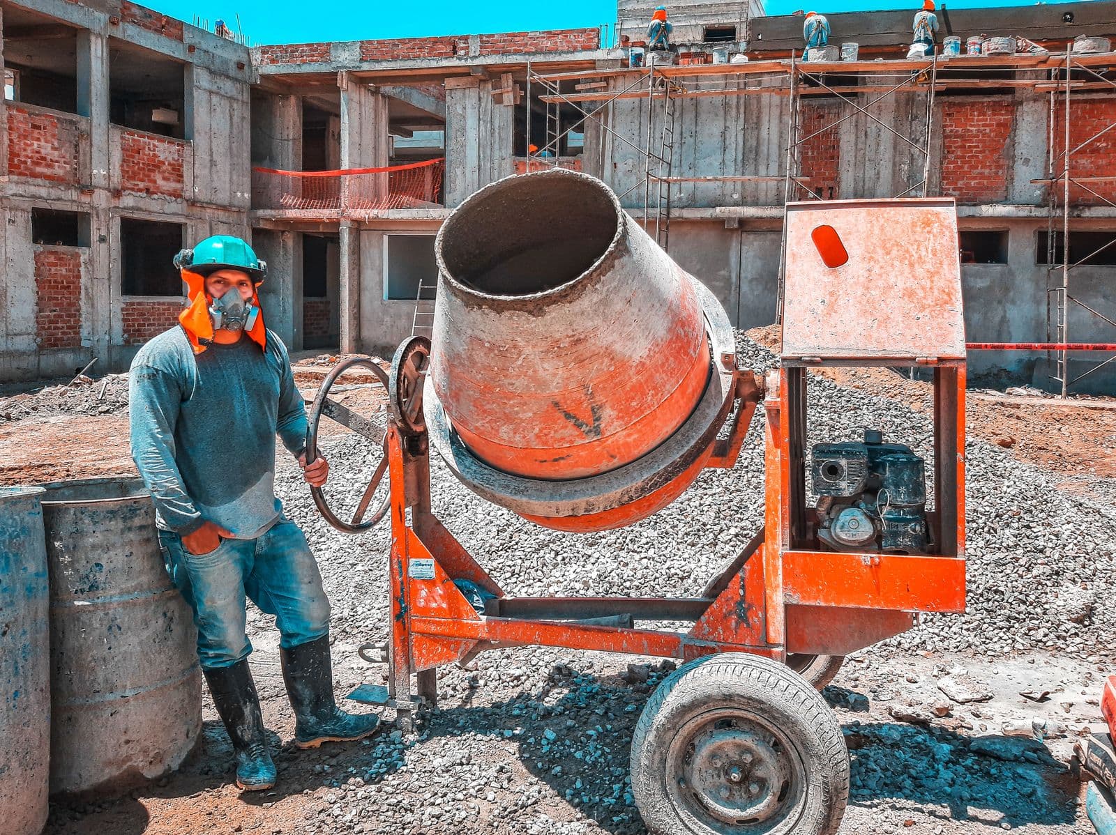 Construction worker operating equipment on an active building site