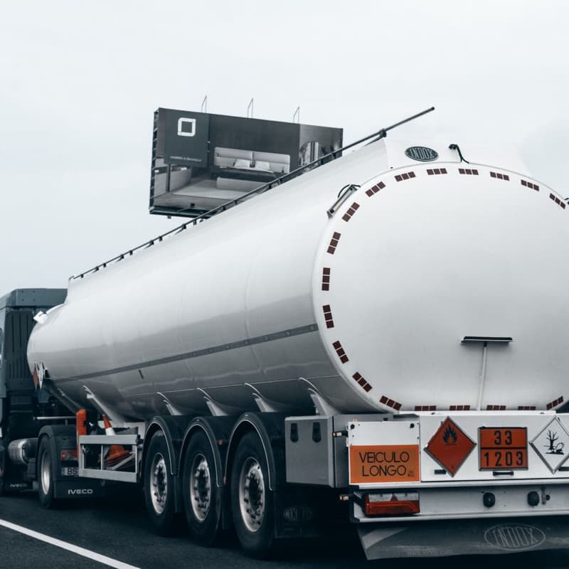 Hazardous freight transport vehicle displaying regulatory placards
