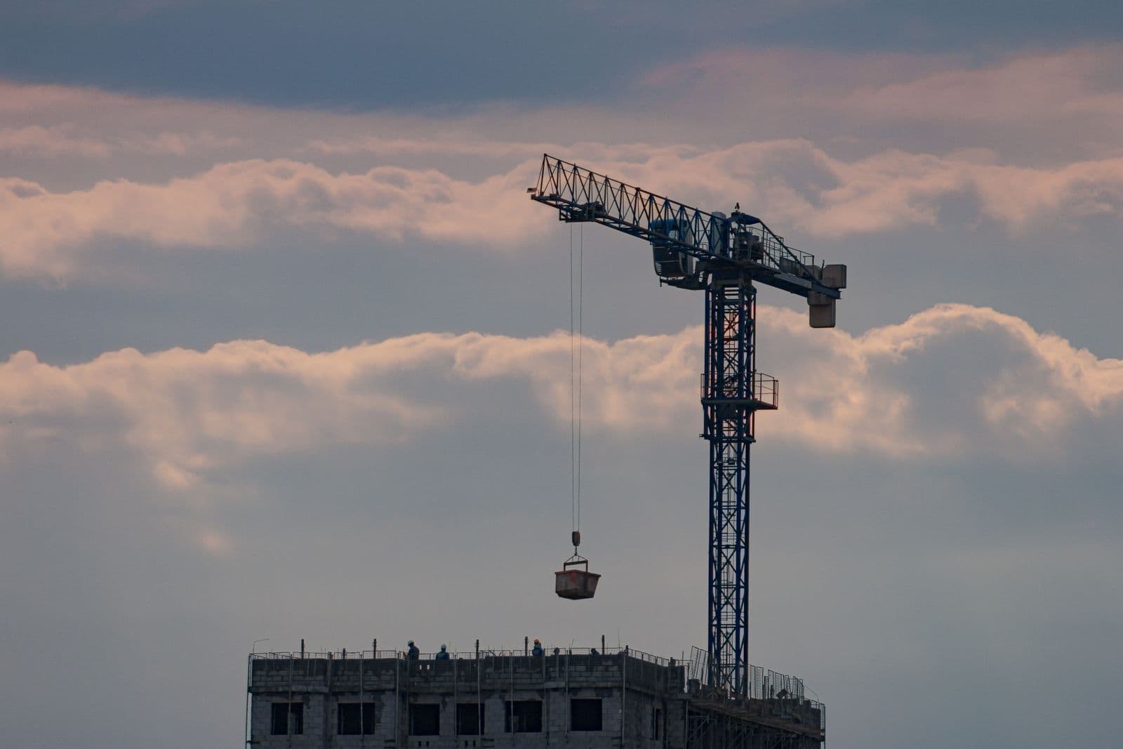 Crane lifting materials above an active UK construction site