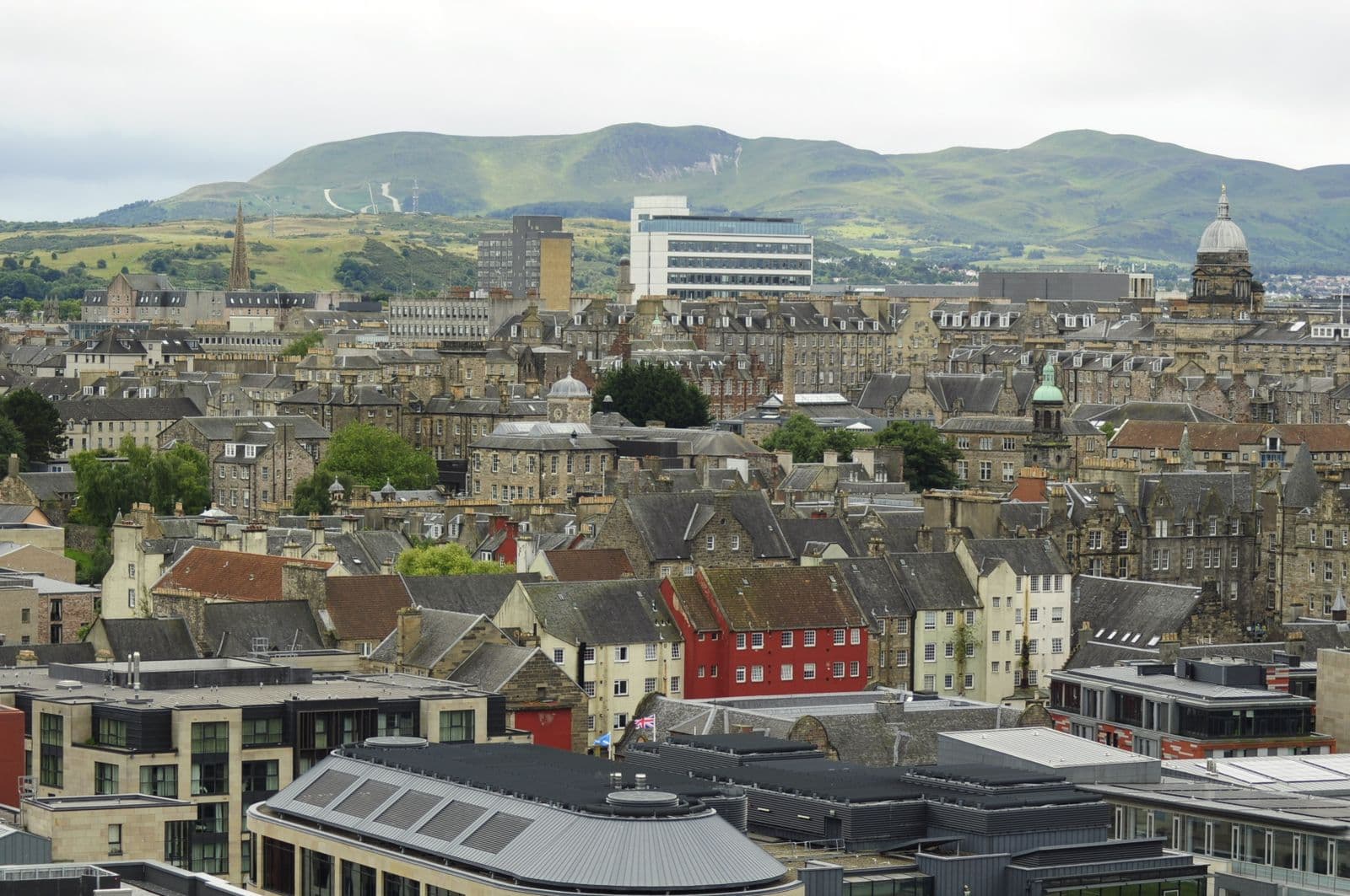 Historic Edinburgh rooftops with Arthur's Seat in the distance