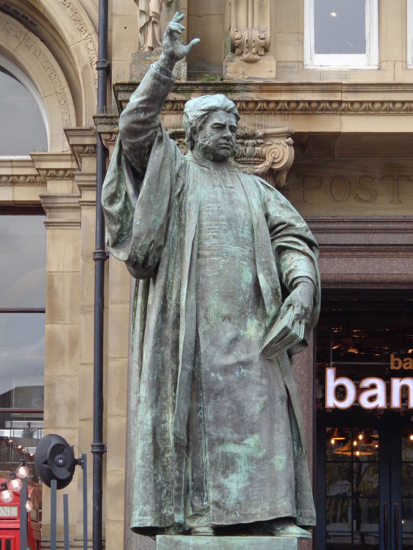 Historic bronze statue and stone architecture in Leeds city centre